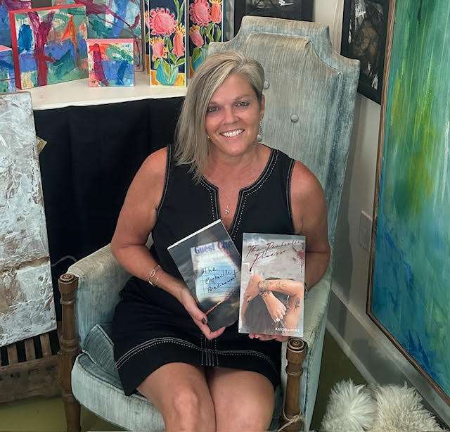 Kendra Hoey with her books at an art gallery